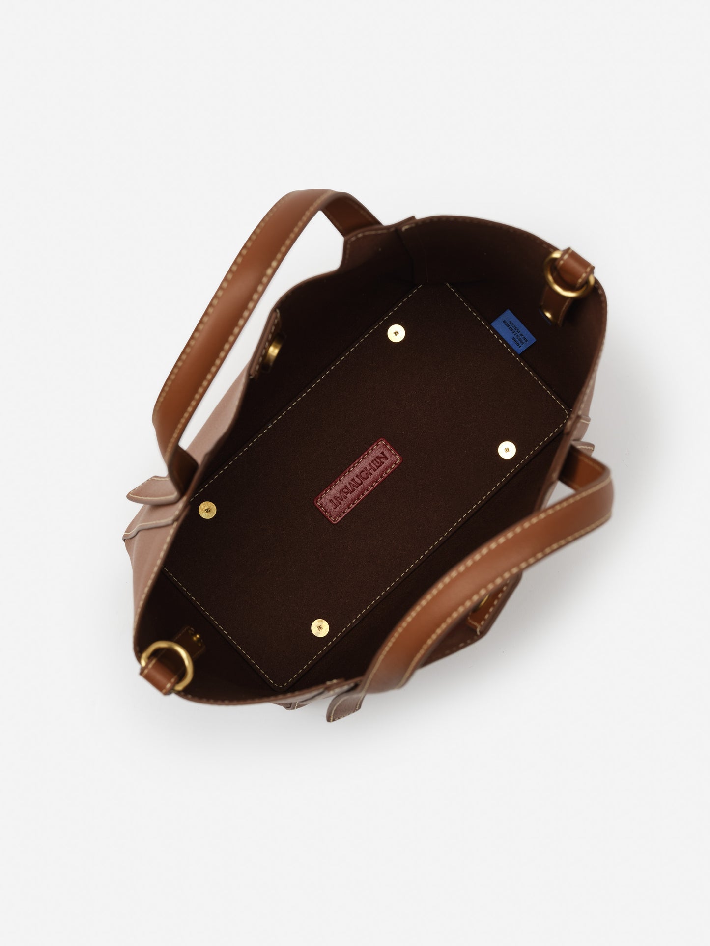 Interior view of the Lane Leather Mini Tote by J.McLaughlin showcasing its rich saddle brown leather, sturdy handles, and meticulous craftsmanship, embodying effortlessly stylish and enduring designs from a destination for defining style. Life, Well-Lived.
