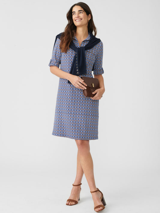 Model wears J.McLaughlin Lawrence Dress in Ogee Geo in navy/blue/tan made with 100% cotton.