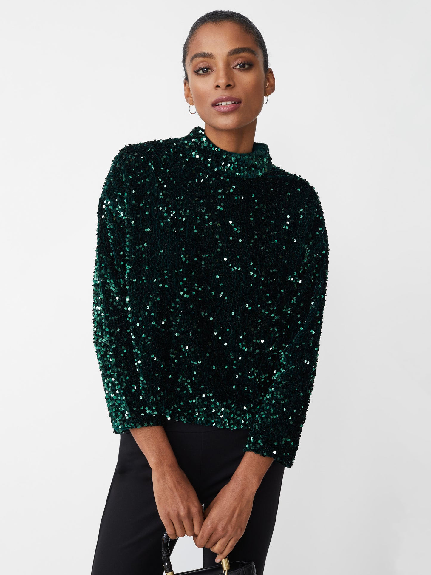 Model wearing J.McLaughlin Leeza top in emerald green made with polyester.