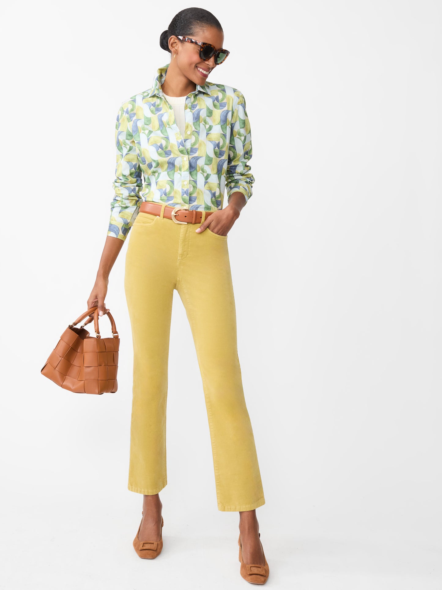 Model wearing J.McLaughlin Lenni jeans in chartreuse made with velveteen.