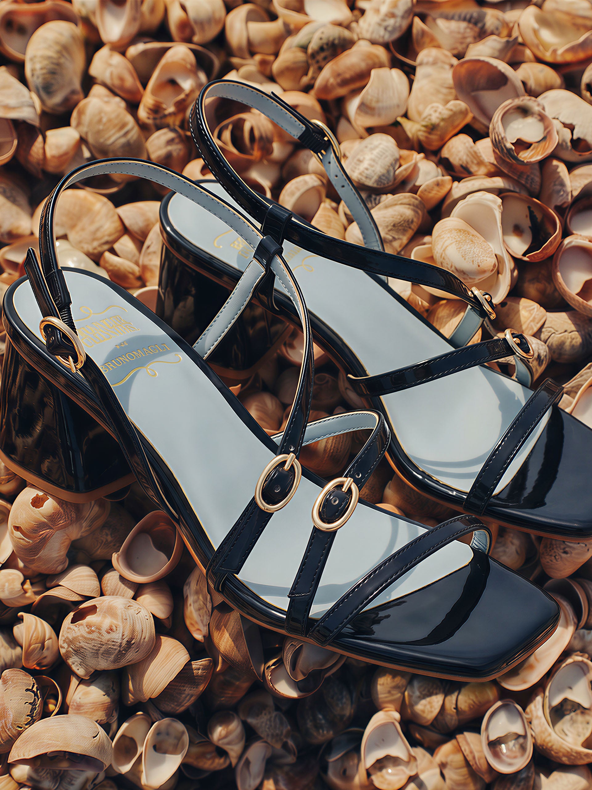 Lexi Heels by J.McLaughlin featuring sleek navy patent leather with gold buckles, combining effortlessly stylish design and enduring quality for a legacy of timeless fashion.