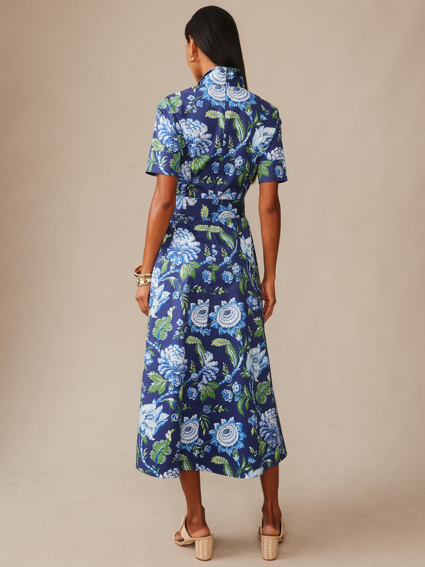 Woman wearing a J.McLaughlin Lily Dress in Cerulean Garden featuring a vibrant floral pattern in blue and green, combining effortlessly stylish, enduring designs with innovative fabrics.