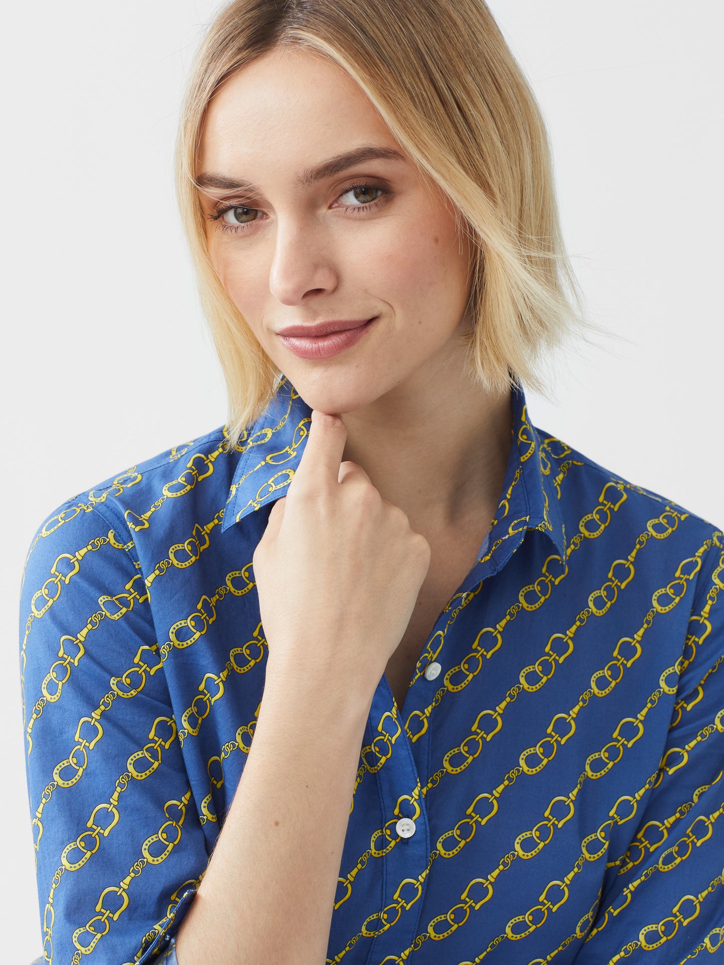 Model wearing J.McLaughlin Lois shirt in medium blue/gold made with cotton.