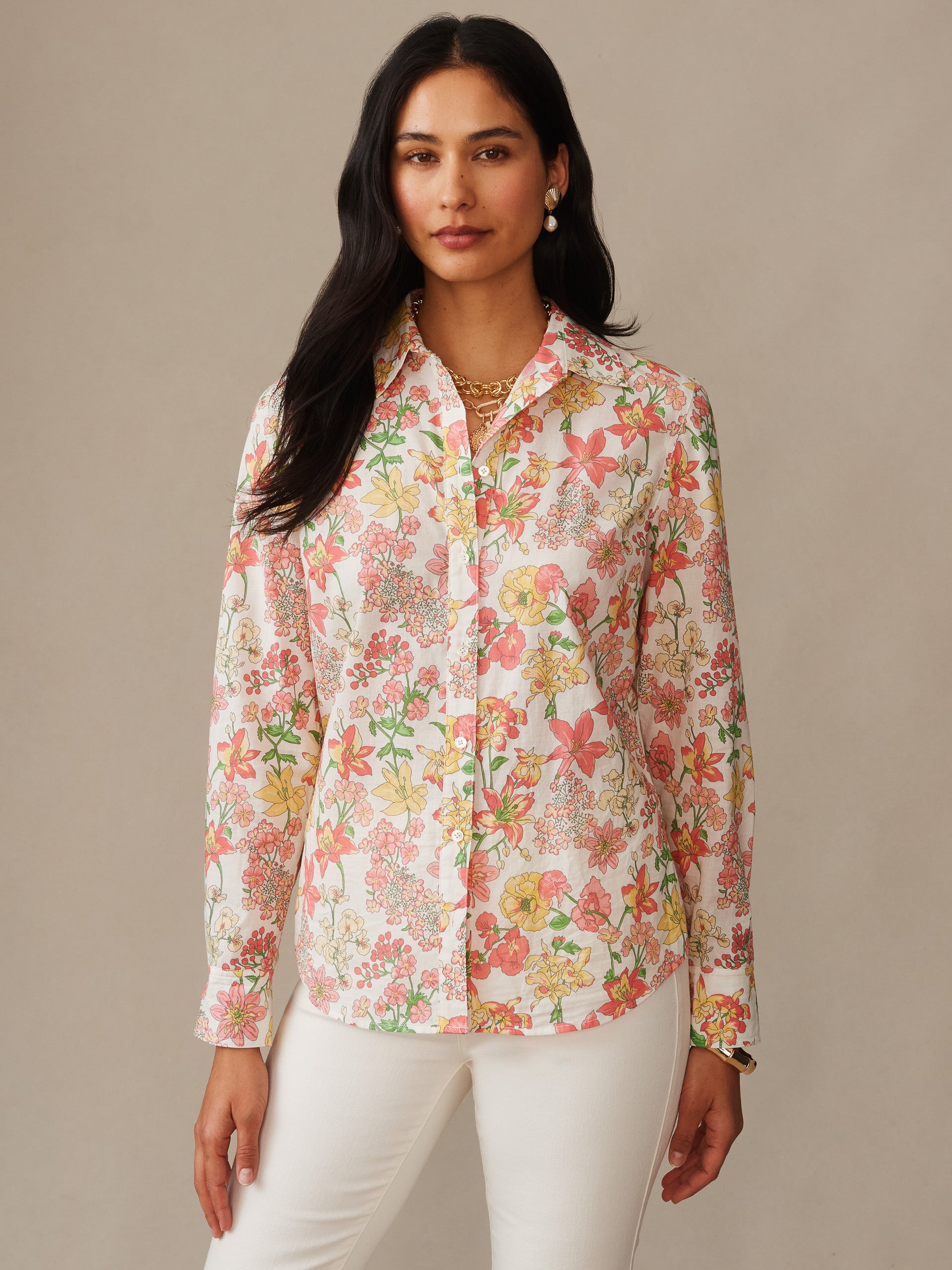 Woman wearing a J.McLaughlin Lois Shirt in Floral Villa featuring a floral pattern in soft pink, yellow, and green hues, embodying effortlessly stylish and enduring designs.