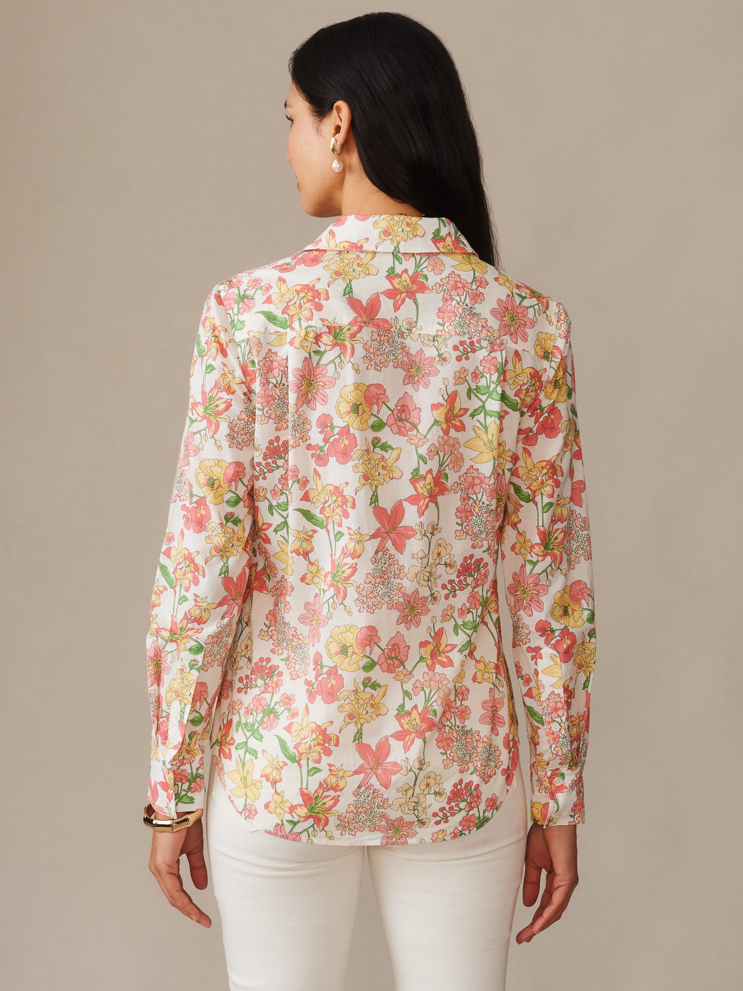 Back view of a woman wearing the Lois Shirt in Floral Villa by J.McLaughlin, featuring a delicate floral pattern in soft pink, yellow, and green tones, showcasing effortlessly stylish design and enduring appeal for a life well-lived.