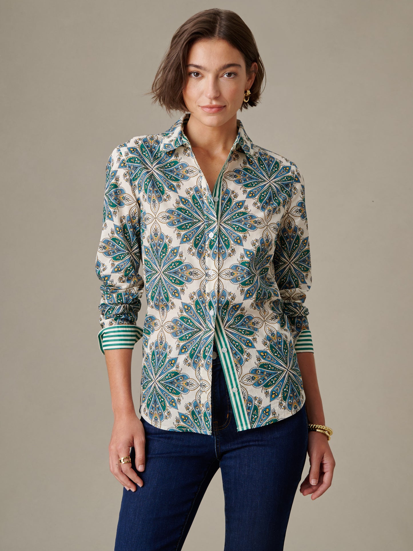 Woman wearing the Lois Shirt in Neo Radiant Stripe by J.McLaughlin, featuring a bold floral pattern with a striped inner cuff design, embodying effortless style and timeless elegance.