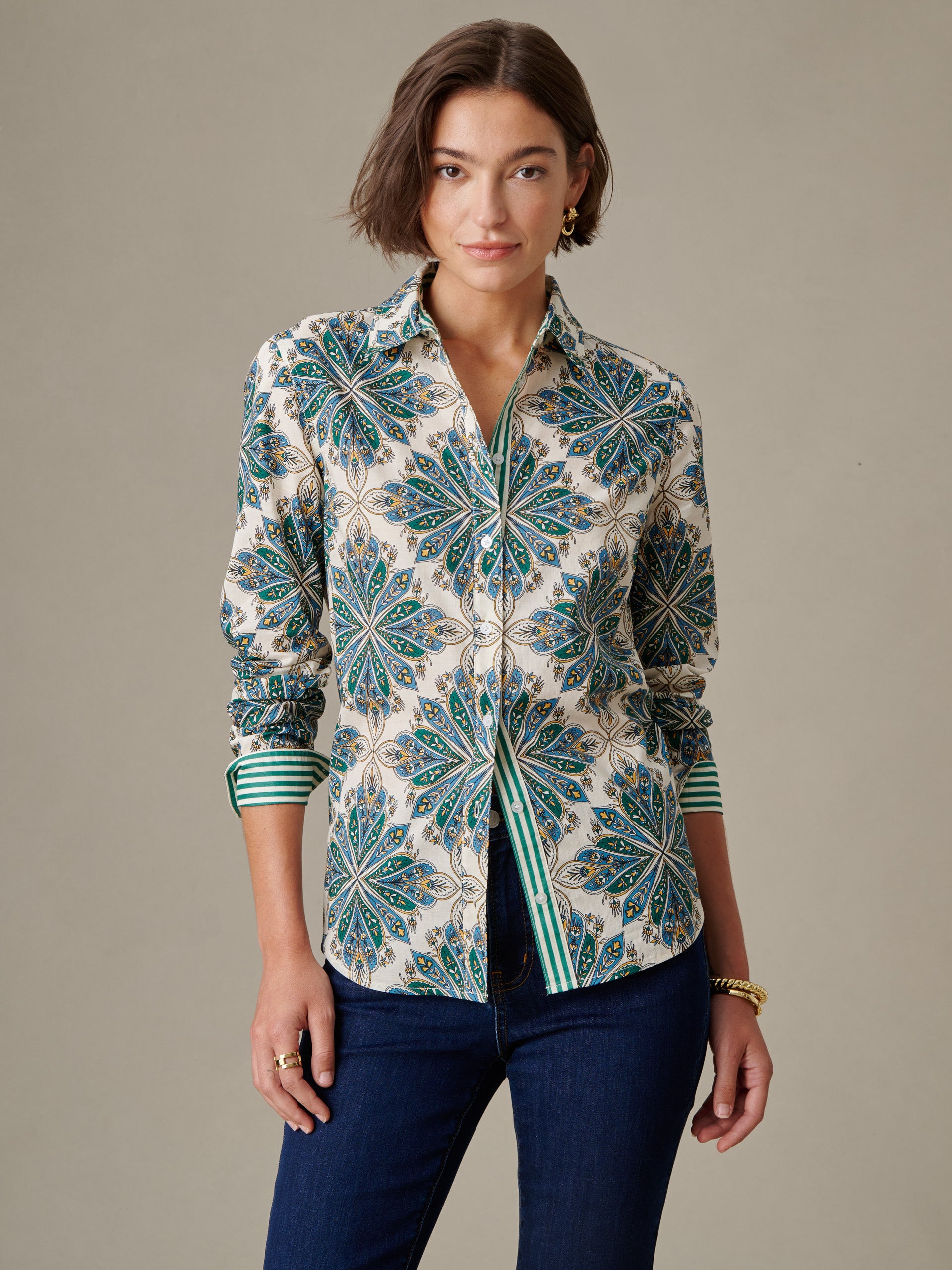 Woman wearing the Lois Shirt in Neo Radiant Stripe by J.McLaughlin, featuring a bold floral pattern with a striped inner cuff design, embodying effortless style and timeless elegance.