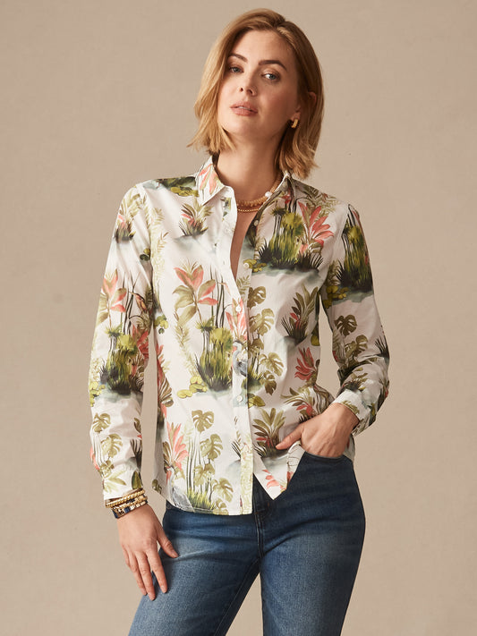 Woman wearing a Lois Shirt in Tidal Palms by J.McLaughlin featuring a tropical print in green and coral tones paired with jeans, showcasing effortlessly stylish, enduring designs and innovative fabrics.