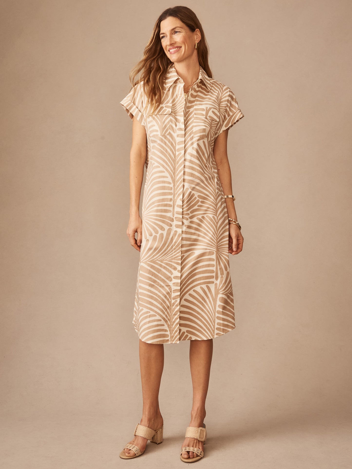 Woman wearing Luciana Dress in Mod Frond by J.McLaughlin, featuring a tan and off-white pattern with short sleeves and a classic collar, embodying effortlessly stylish, enduring designs for a life well-lived.