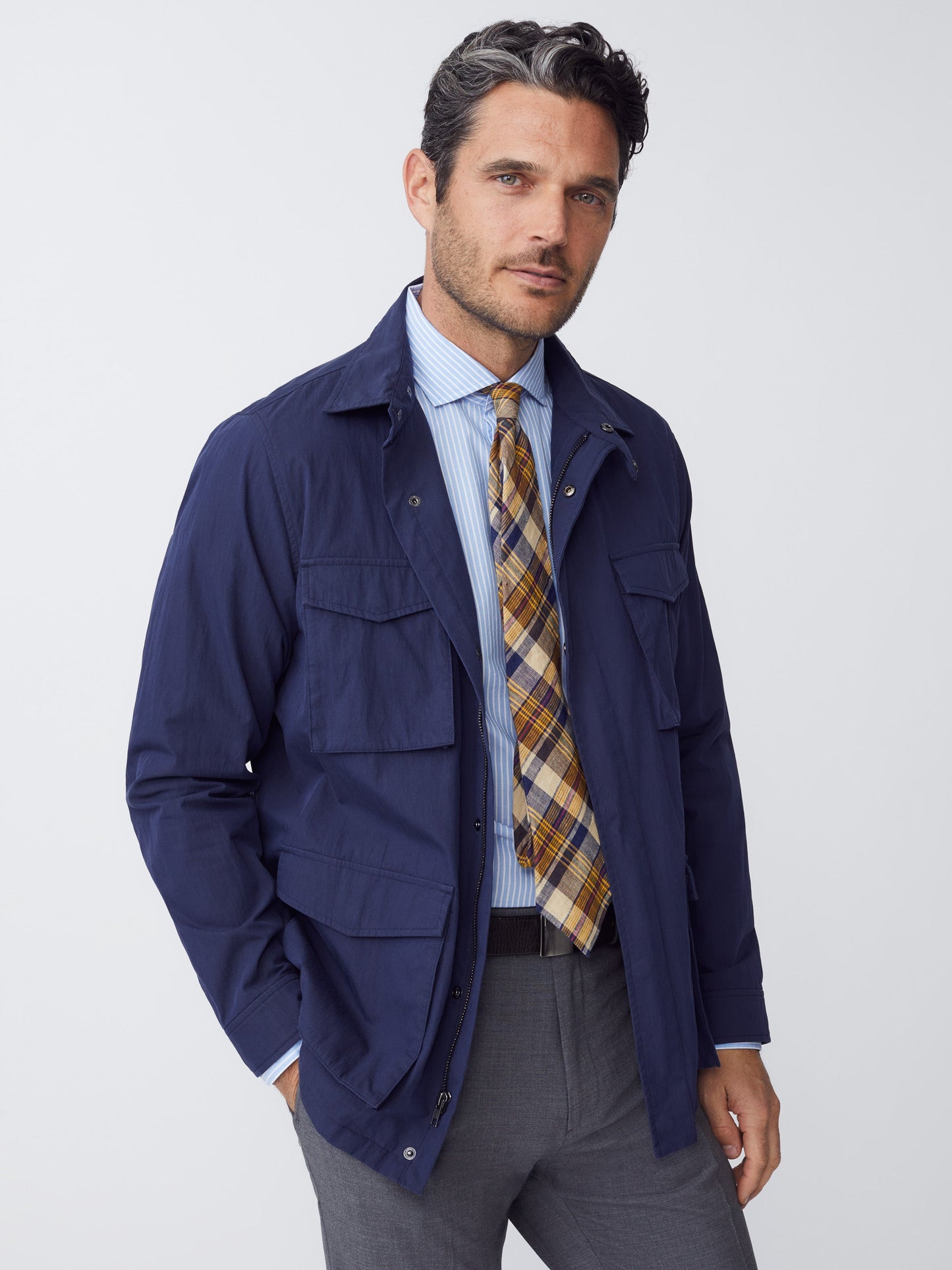Model wearing J.McLaughlin Madaket safari jacket in navy made with cotton/nylon.