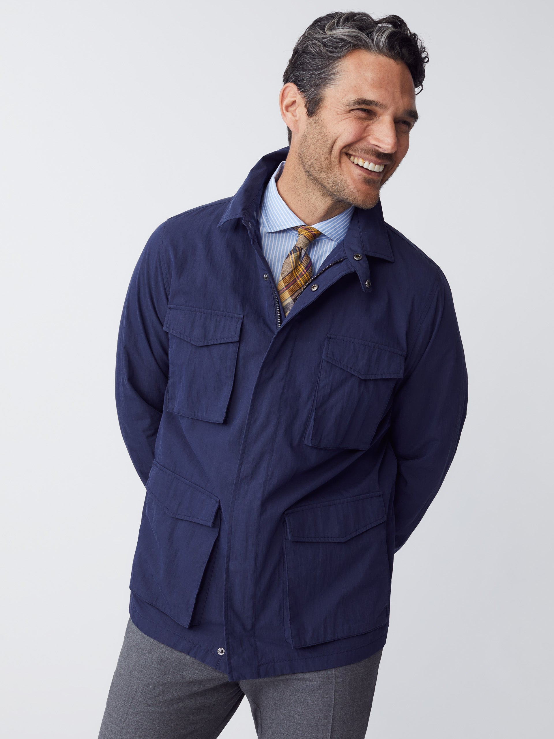 Model wearing J.McLaughlin Madaket safari jacket in navy made with cotton/nylon.