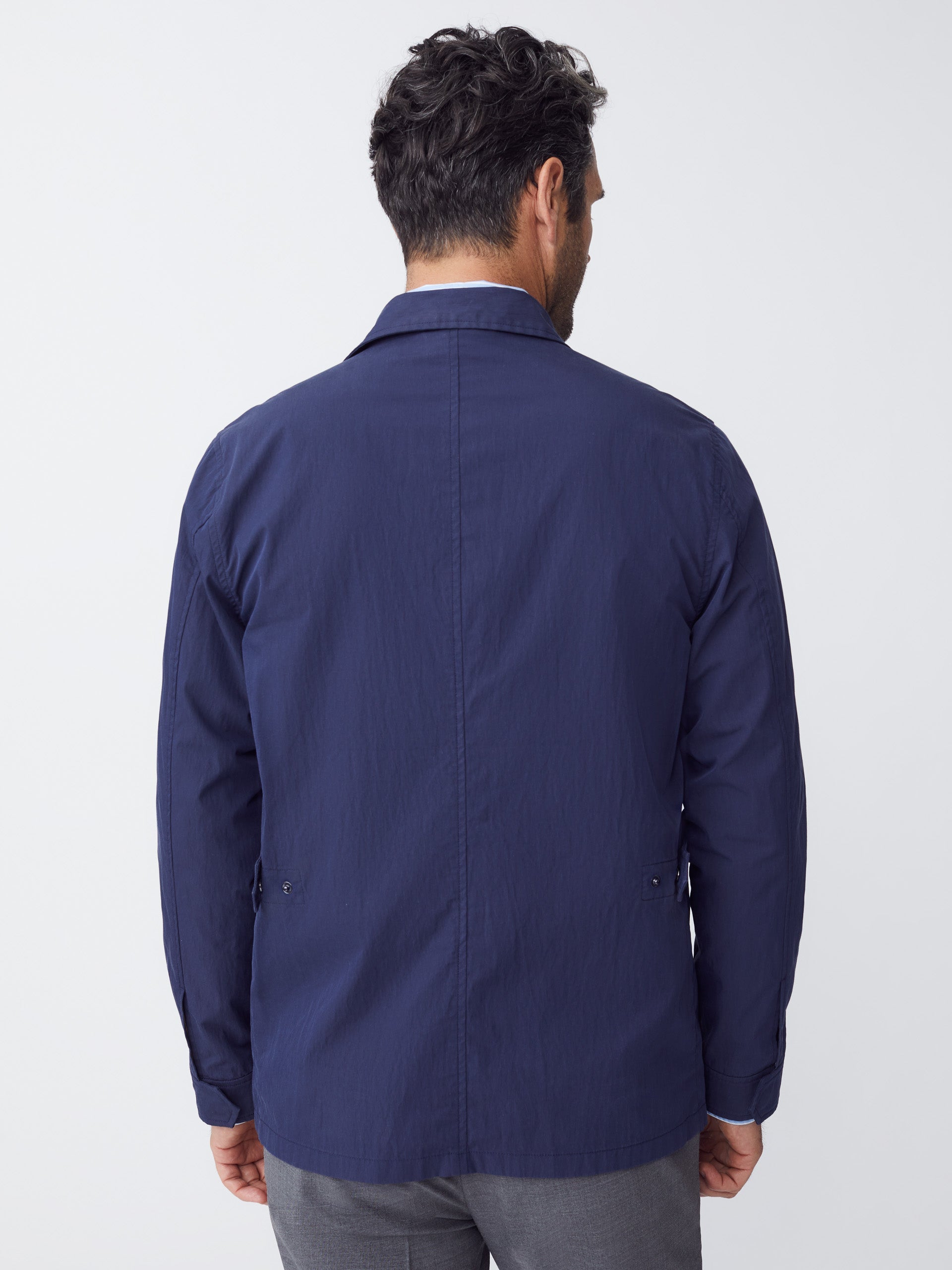 Model wearing J.McLaughlin Madaket safari jacket in navy made with cotton/nylon.