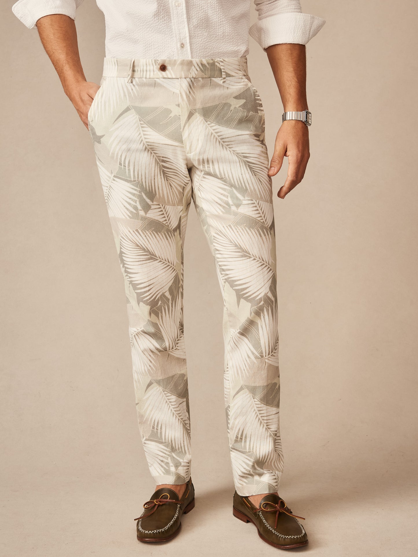 Man wearing Madison Fancy Pants in Vibrant Palms by J.McLaughlin, featuring an effortlessly stylish tropical leaf pattern with innovative fabrics and enduring designs, a destination for defining style. Life, Well-Lived.