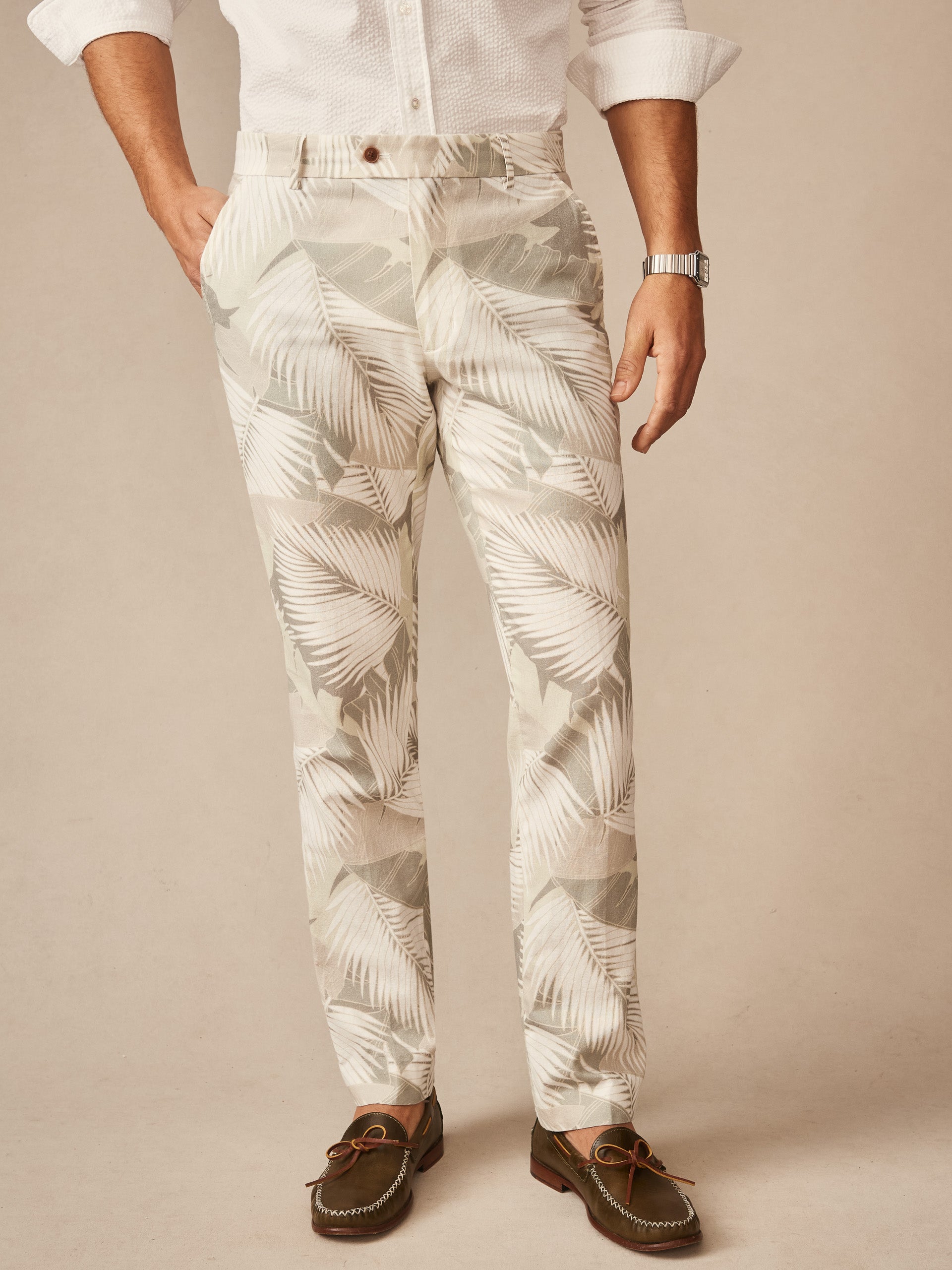 Man wearing Madison Fancy Pants in Vibrant Palms by J.McLaughlin, featuring an effortlessly stylish tropical leaf pattern with innovative fabrics and enduring designs, a destination for defining style. Life, Well-Lived.