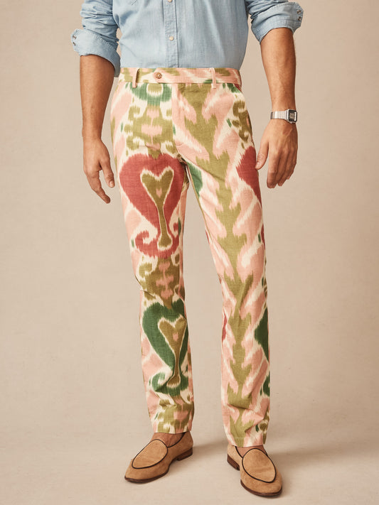 Man wearing Madison Fancy Pants in Ikat by J.McLaughlin featuring green, cream, and red tones paired with a light blue shirt and tan loafers, showcasing effortlessly stylish, enduring designs and innovative fabrics at a destination for defining style. Life, Well-Lived.