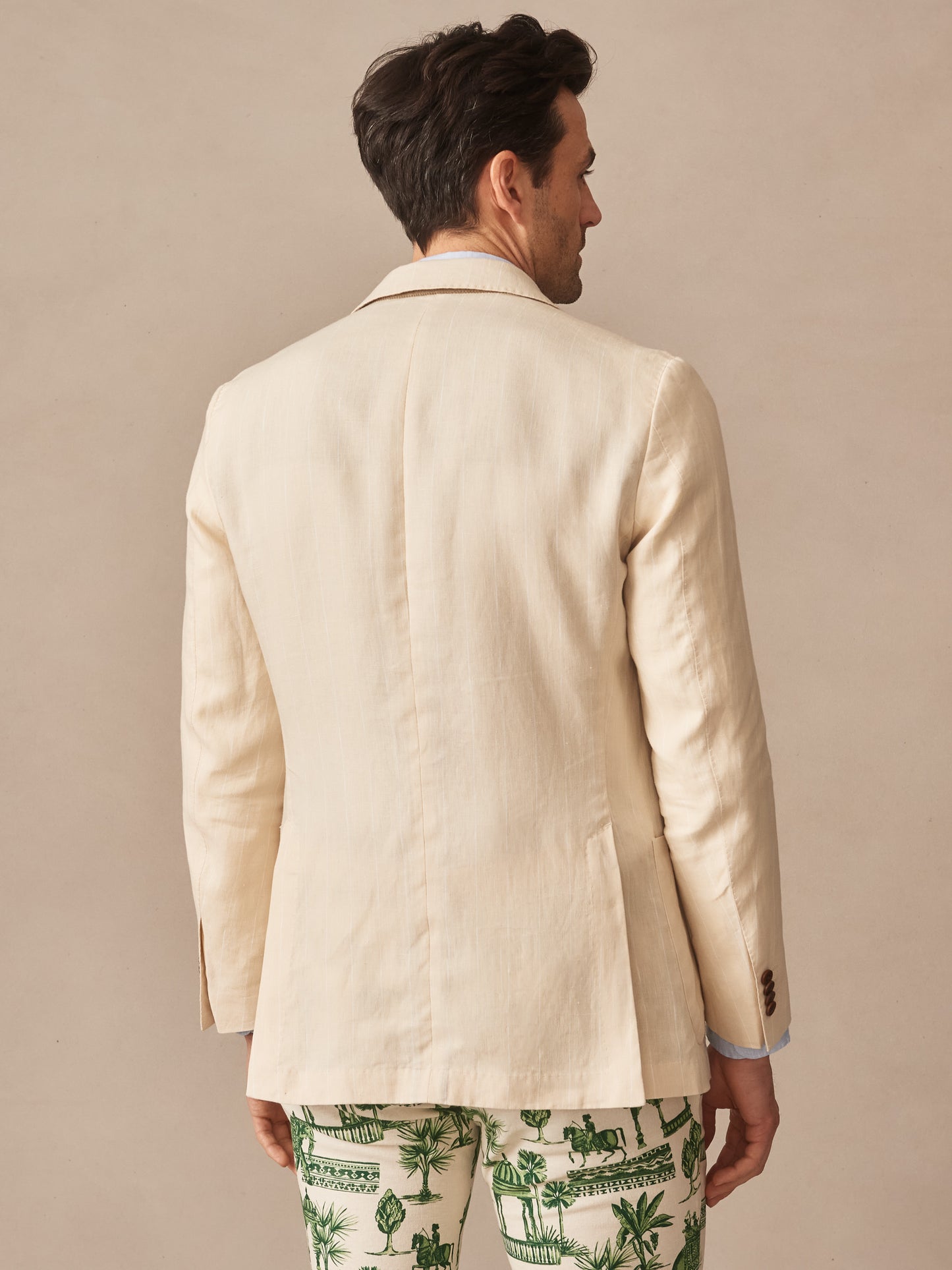 Man wearing a Brera Linen Sport Coat in Pinstripe by J.McLaughlin, showcasing effortlessly stylish and enduring designs crafted from innovative fabrics in a timeless classic style.