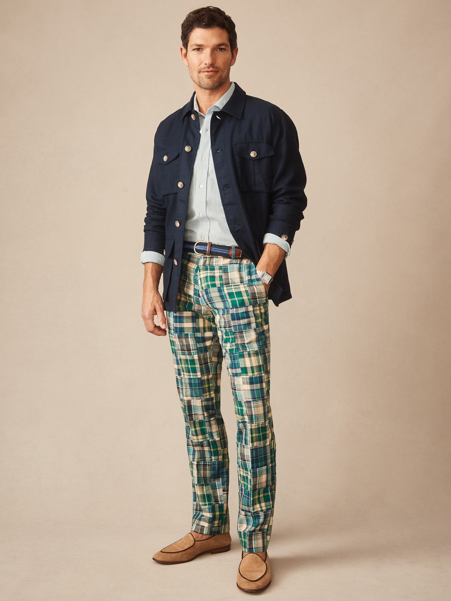 Man wearing J.McLaughlin Madison Fancy Pants in Patchwork with a navy jacket, light blue shirt, and tan loafers, showcasing effortlessly stylish, enduring designs and innovative fabrics.