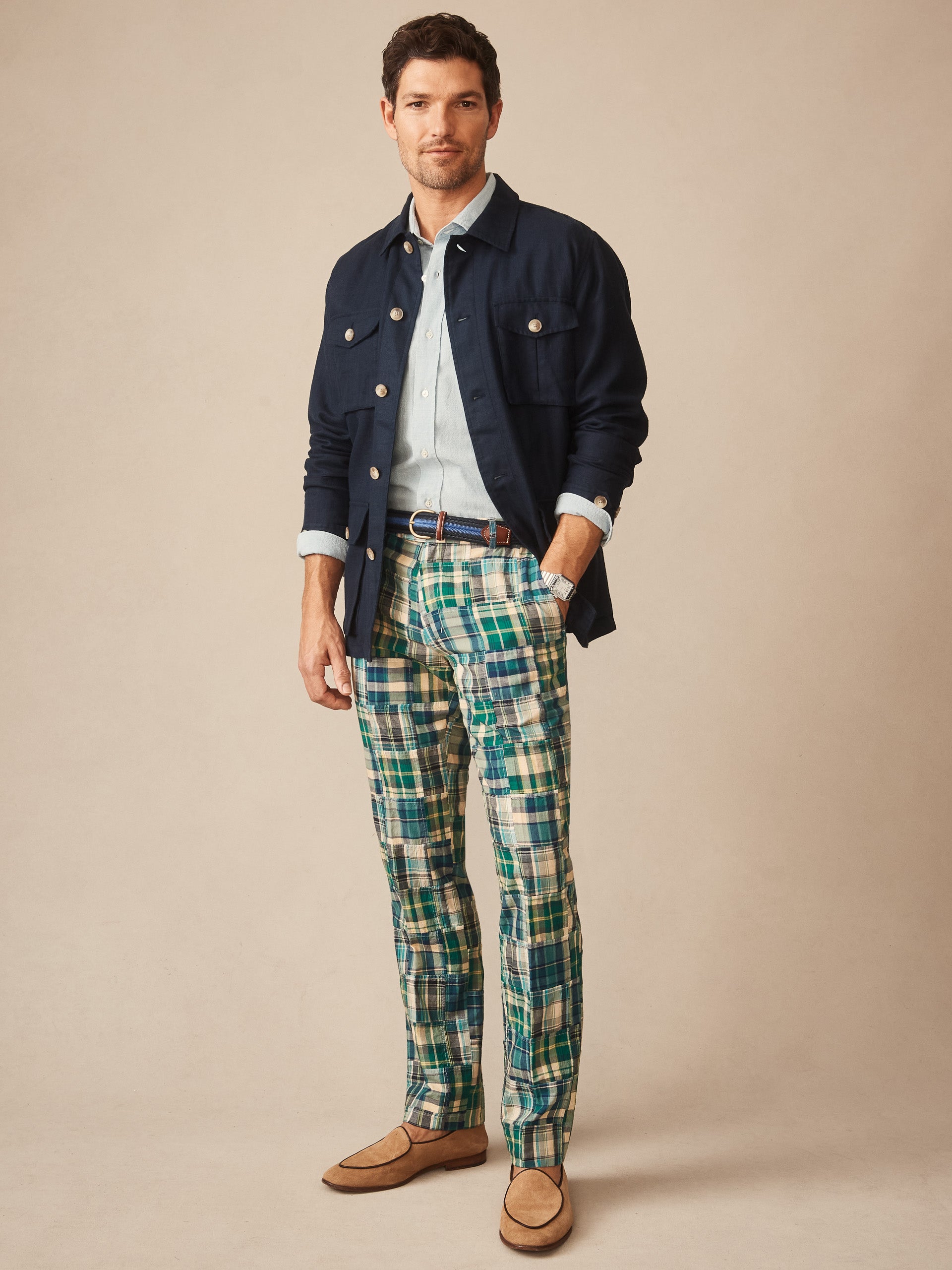 Man wearing J.McLaughlin Madison Fancy Pants in Patchwork with a navy jacket, light blue shirt, and tan loafers, showcasing effortlessly stylish, enduring designs and innovative fabrics.