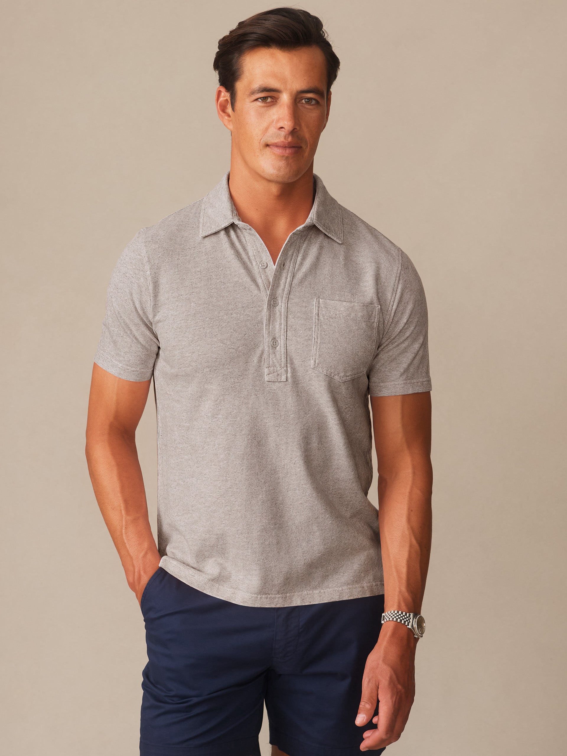 Man wearing a quartz-colored Mantle Pique Polo by J.McLaughlin paired with navy shorts, showcasing effortlessly stylish, enduring designs and innovative fabrics for a legacy of timeless fashion. A destination for defining style. Life, Well-Lived.