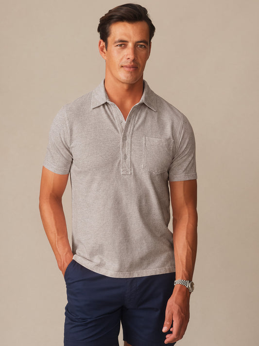 Man wearing a quartz-colored Mantle Pique Polo by J.McLaughlin paired with navy shorts, showcasing effortlessly stylish, enduring designs and innovative fabrics for a legacy of timeless fashion. A destination for defining style. Life, Well-Lived.