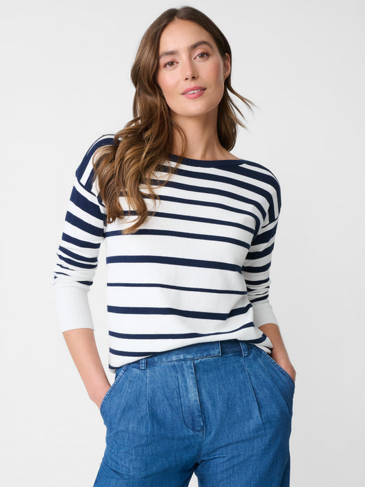 Model wearing J.McLaughlin Marin sweater in white/navy made with cotton./modal.