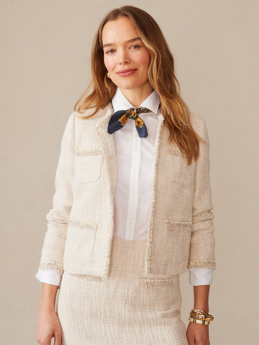 A woman wearing the Martha Bouclé Jacket by J.McLaughlin in a creamy textured fabric over a crisp white shirt with a navy and gold scarf, exemplifying effortlessly stylish, enduring designs with innovative fabrics from a destination for defining style. Life, Well-Lived.