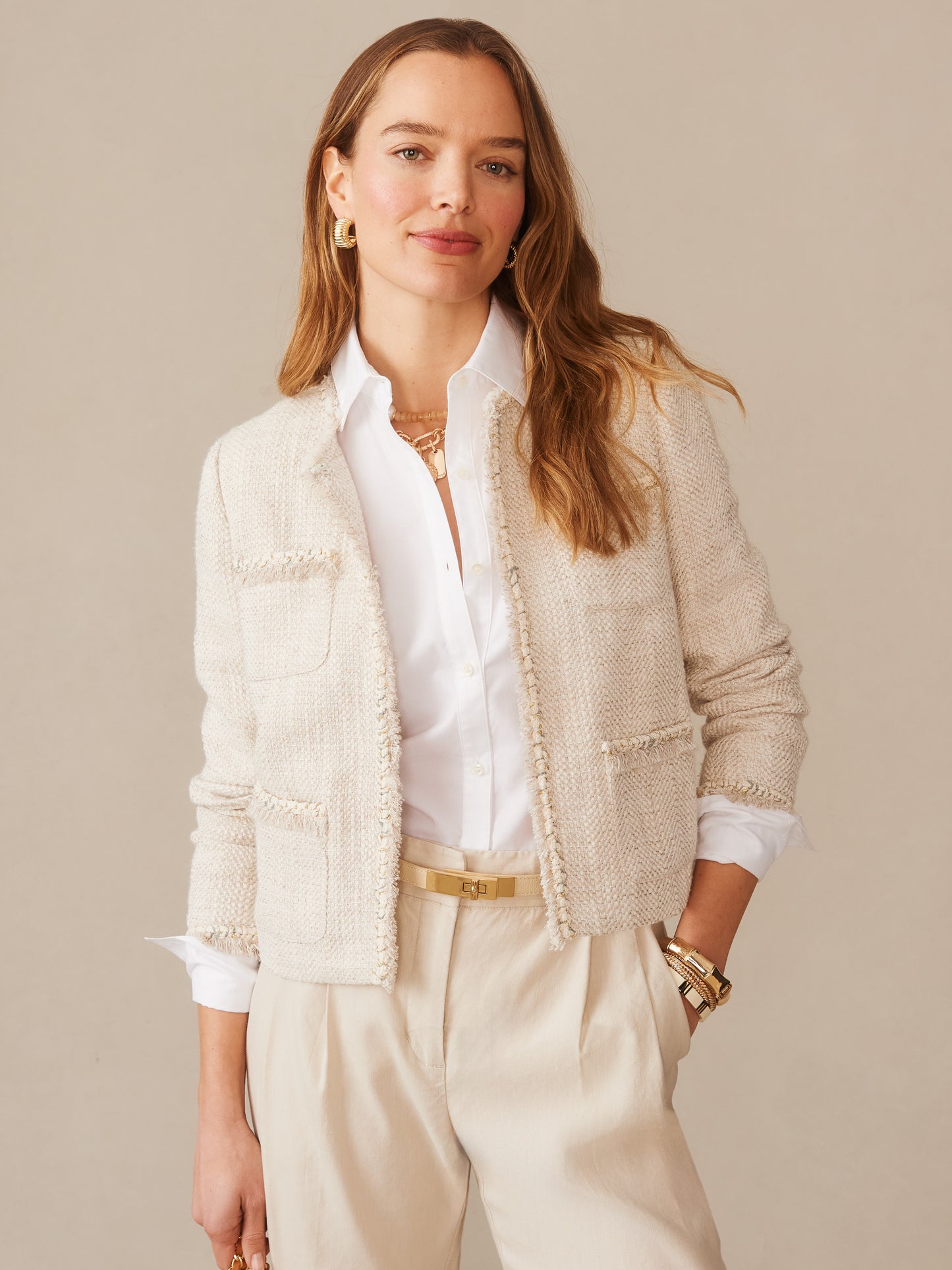 A woman wearing the Martha Bouclé Jacket by J.McLaughlin styled with a crisp white shirt and light beige pants, showcasing effortlessly stylish, enduring designs with innovative fabrics.