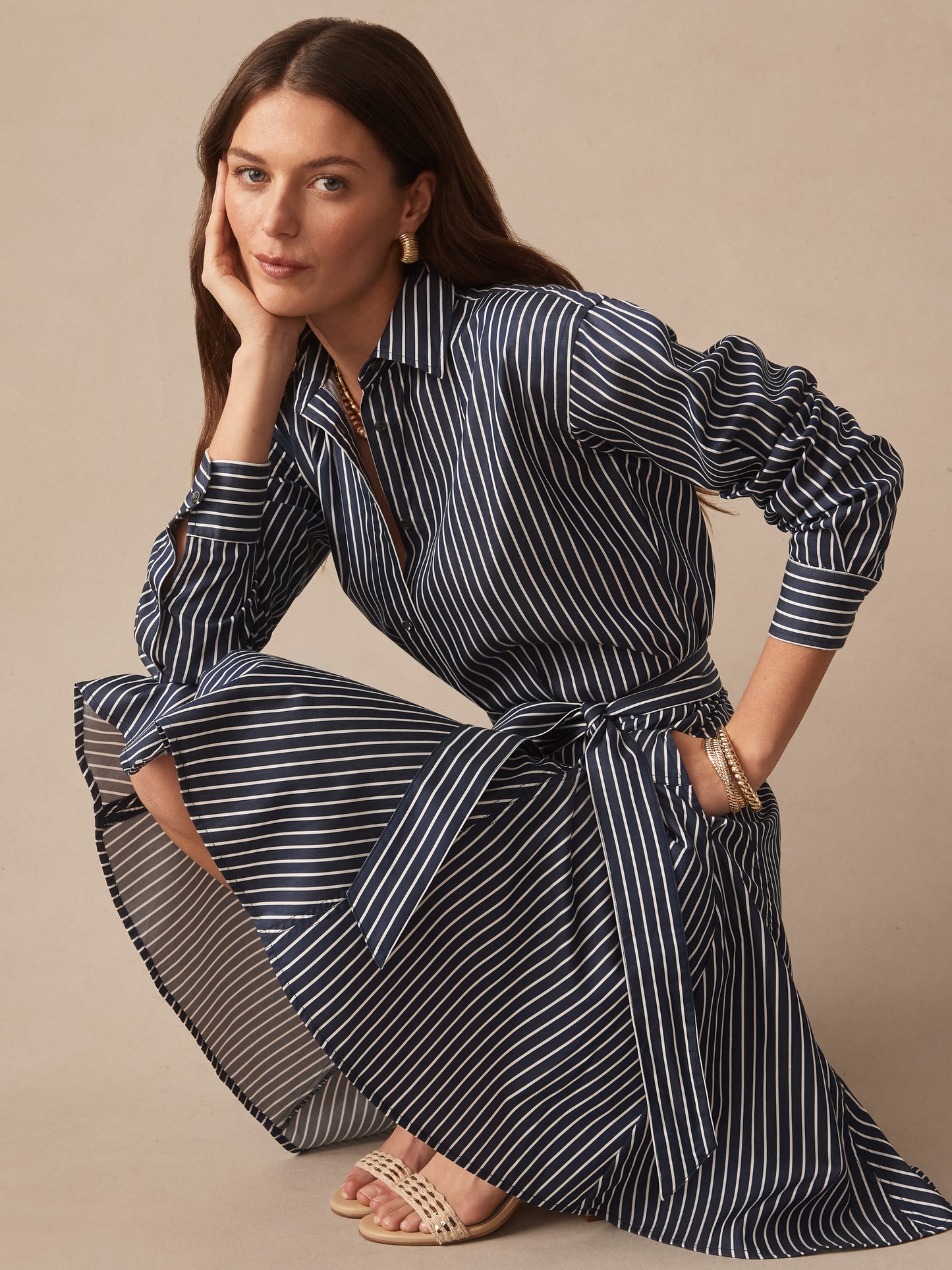 Woman wearing a navy and white striped Mary Dress in Stripe by J.McLaughlin, showcasing effortlessly stylish design and enduring craftsmanship for a life well-lived.