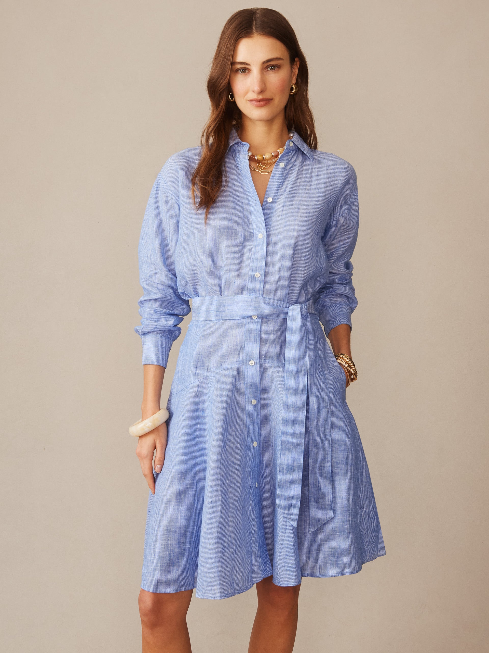 Woman wearing a J.McLaughlin Mary Linen Dress in Stripe, showcasing an effortlessly stylish, classic linen dress with a waist tie and button-down front, embodying enduring designs and a legacy of timeless fashion at a destination for defining style. Life, Well-Lived.