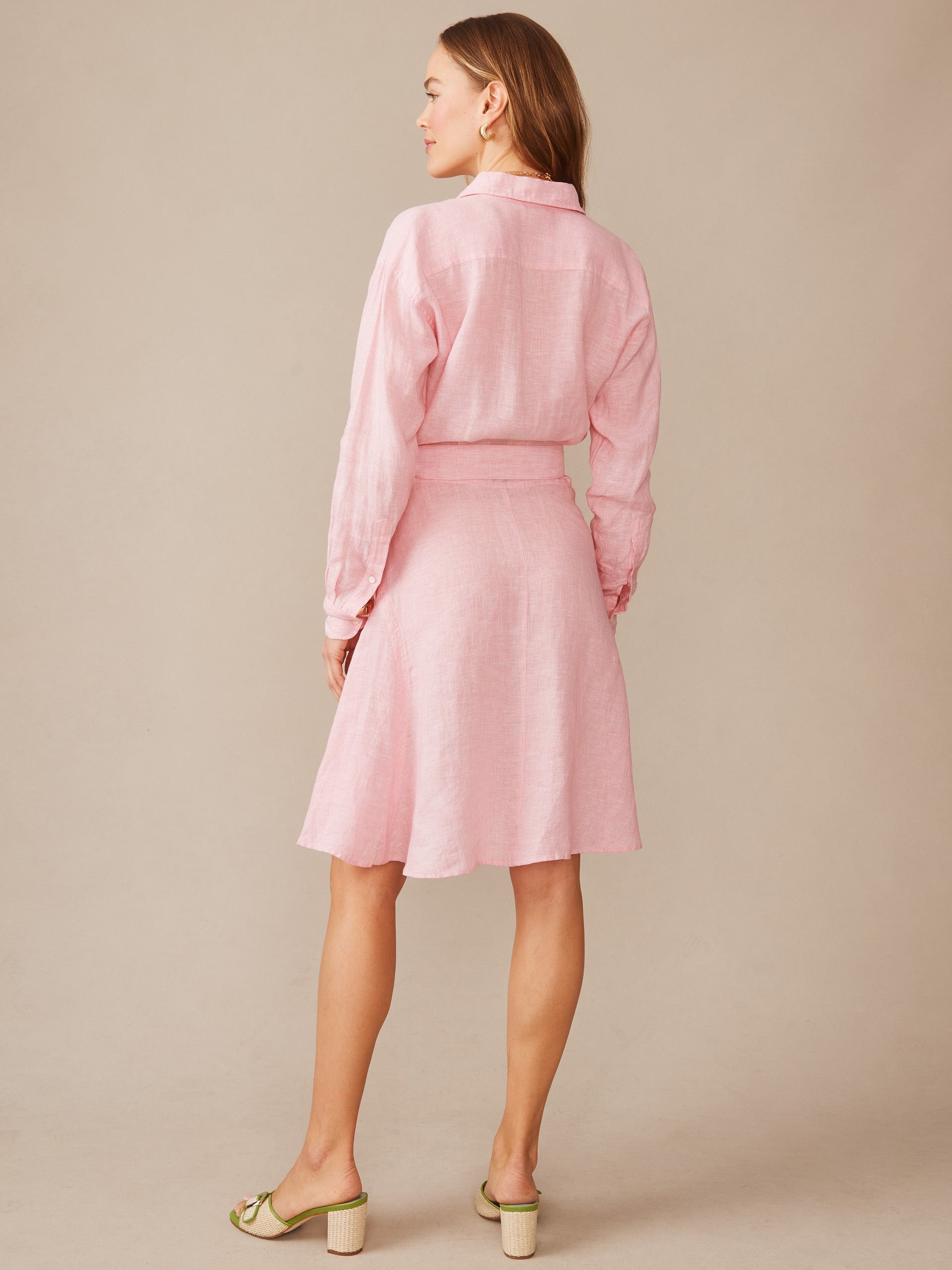 Female model wearing a pink Mary Linen Dress in Stripe by J.McLaughlin, showcasing effortlessly stylish design and enduring craftsmanship, a destination for defining style. Life, Well-Lived.