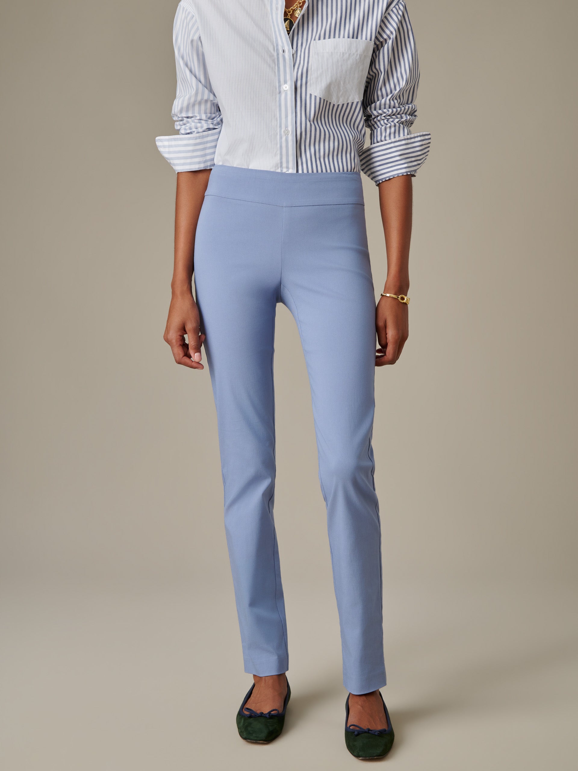 Woman wearing light blue Masie Pants by J.McLaughlin paired with a striped button-down shirt, showcasing effortless style and classic craftsmanship.