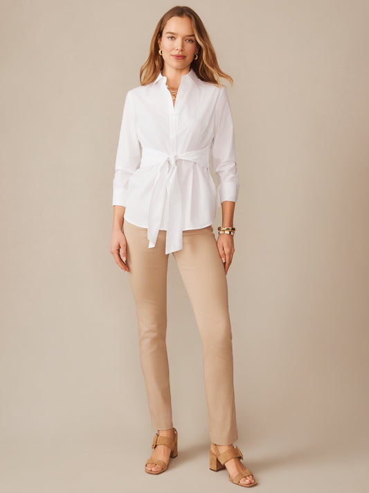 Woman wearing Masie Pants in a warm neutral tone paired with a white blouse, showcasing J.McLaughlin’s effortlessly stylish, enduring designs and innovative fabrics.