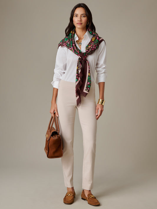 Woman wearing Masie Pants by J.McLaughlin styled with a white shirt, colorful patterned scarf, brown loafers, and a brown handbag, showcasing an effortlessly stylish, timeless look.