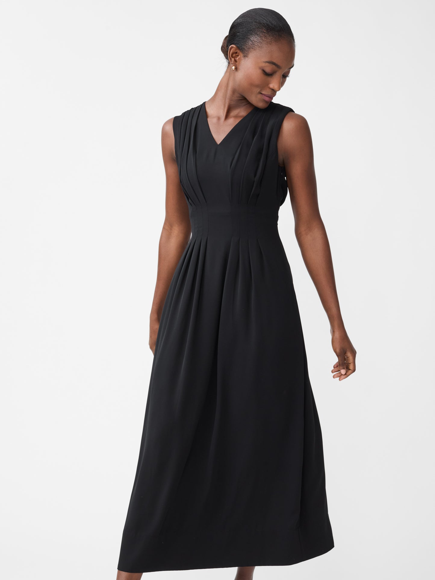 Model wearing J.McLaughlin Maude dress in black made with polyester.