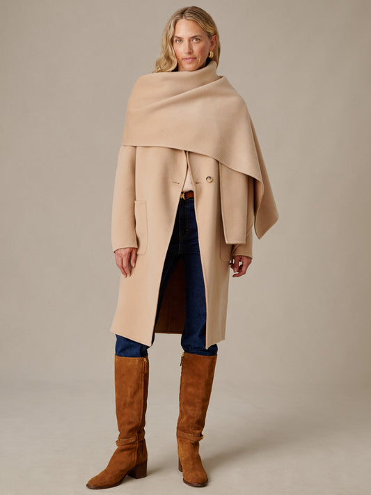 J.McLaughlin Maura Reversible Coat in tonal beige with draped shoulder wrap styling paired with dark jeans and tall brown boots
