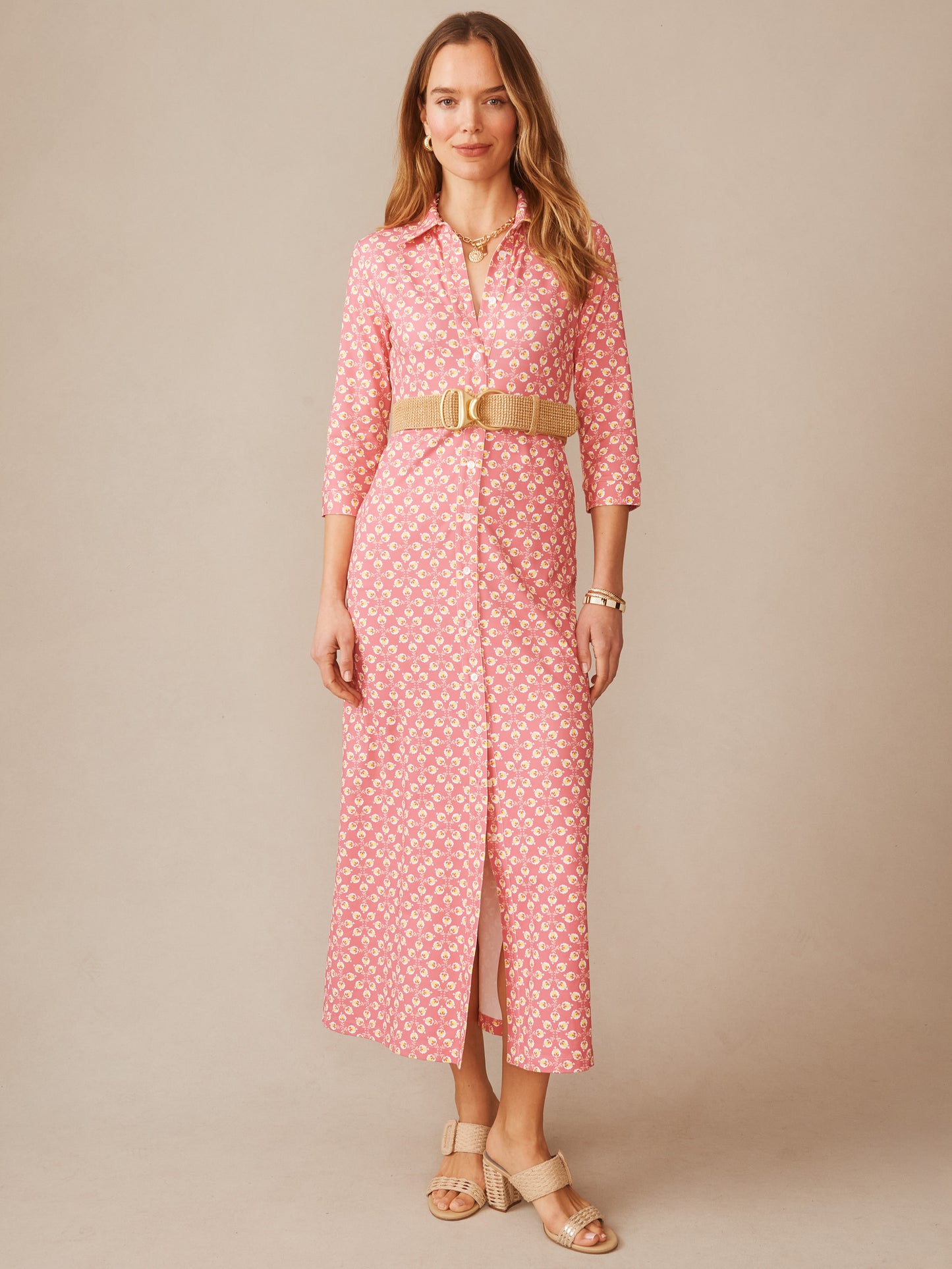 Woman wearing a Kailyn Maxi Dress in Mythic Floral Geo by J.McLaughlin, featuring a pink and yellow floral pattern, belted waist, and three-quarter sleeves, showcasing effortlessly stylish, enduring designs with innovative fabrics for a legacy of timeless fashion. A destination for defining style. Life, Well-Lived.