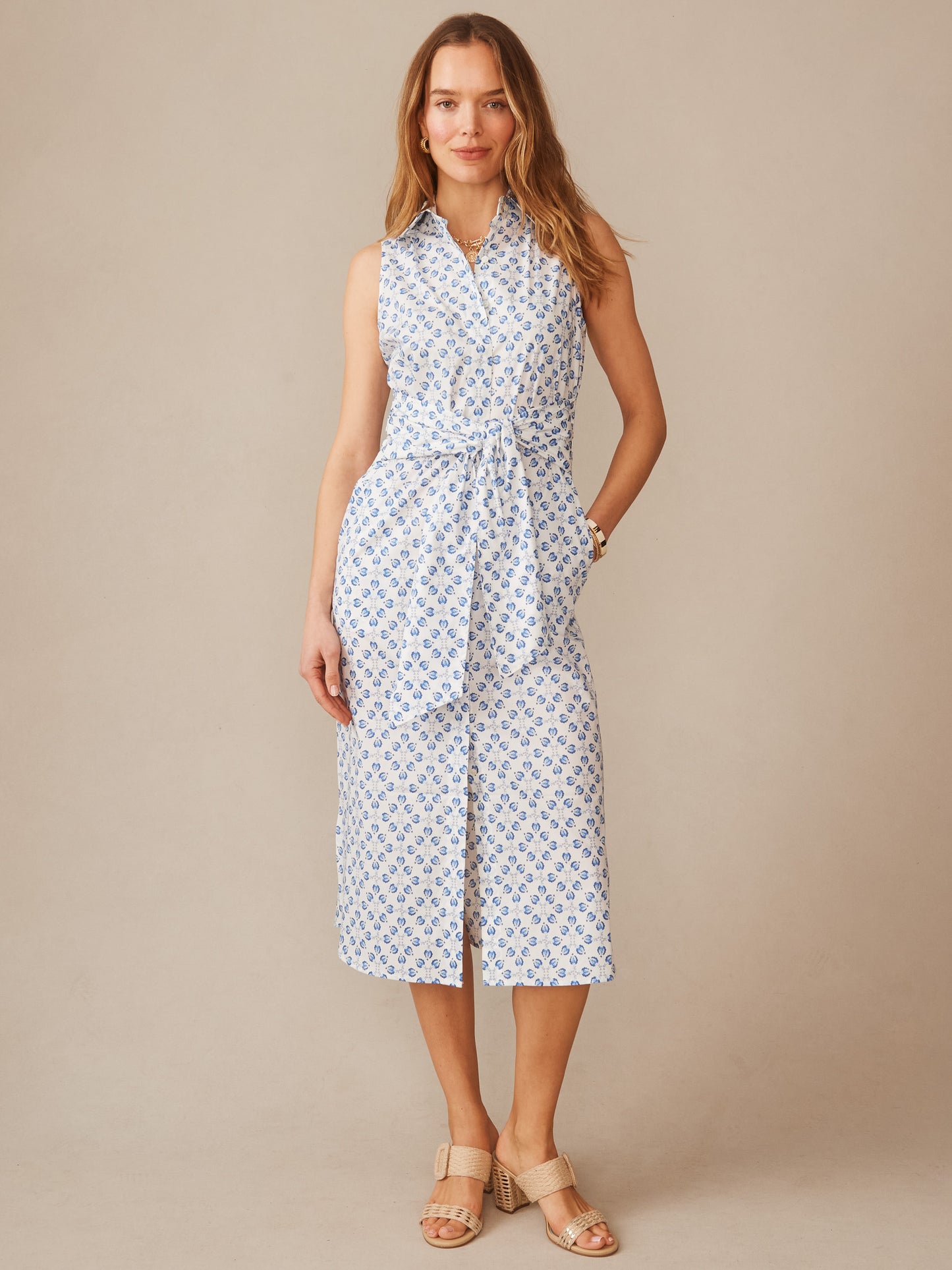 Woman wearing an Orla Sleeveless Linen Dress in Mythic Floral Geo by J.McLaughlin, featuring a classic sleeveless design and floral pattern, embodying effortlessly stylish, enduring designs with innovative fabrics. A destination for defining style. Life, Well-Lived.