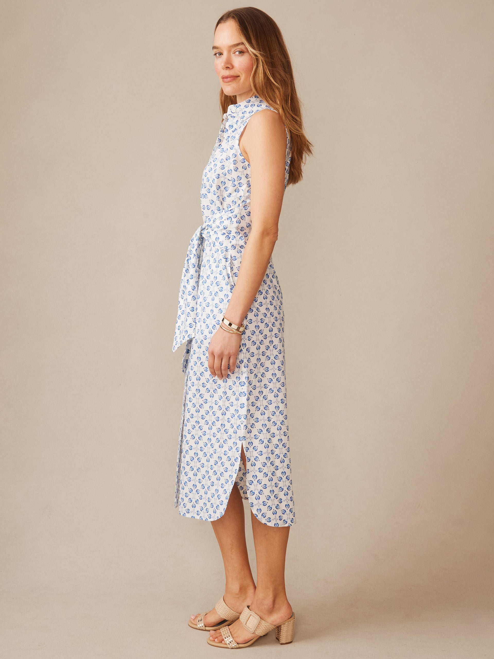 Woman wearing an effortlessly stylish Orla Sleeveless Linen Dress in Mythic Floral Geo by J.McLaughlin, showcasing enduring designs and innovative fabrics for a timeless look.