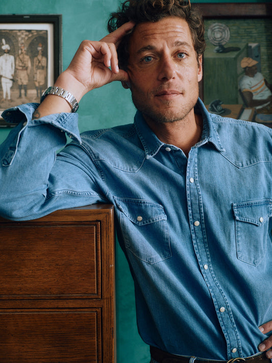 Model wearing J.McLaughlin Ace shirt in light denim made with cotton.