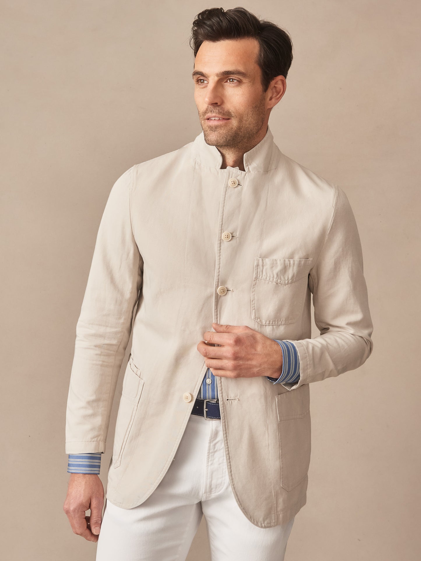 A man wearing the effortlessly stylish Charlestown Jacket by J.McLaughlin, featuring innovative fabrics and enduring designs that reflect a legacy of timeless fashion. A destination for defining style. Life, Well-Lived.