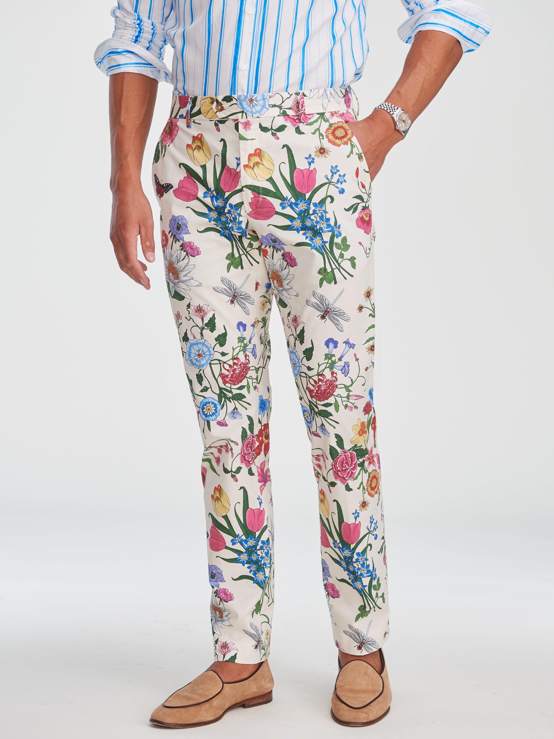 Man wearing Madison Fancy Pants in Dragonfly Garden by J.McLaughlin, featuring classic floral and dragonfly print on light fabric paired with a striped shirt and suede loafers, embodying effortlessly stylish, enduring designs with innovative fabrics, a legacy of timeless fashion. A destination for defining style. Life, Well-Lived.