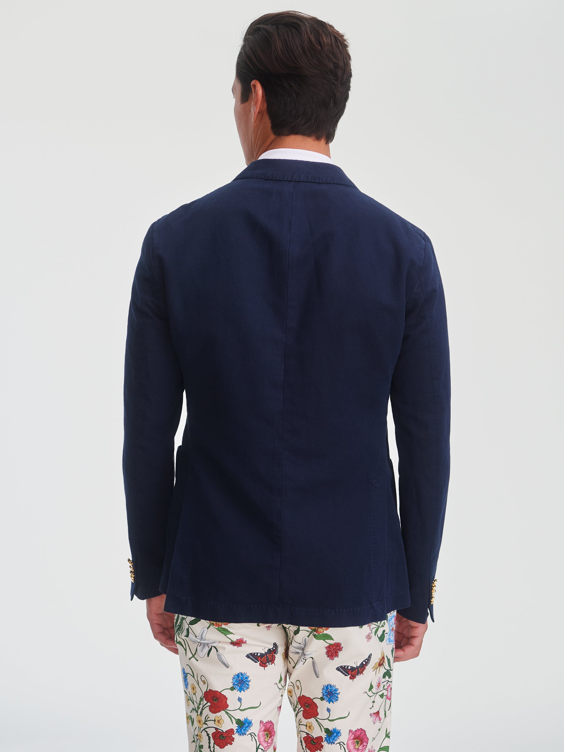 Man wearing a navy Mark Sport Coat by J.McLaughlin, showcasing effortlessly stylish, enduring designs with innovative fabrics in a legacy of timeless fashion. A destination for defining style. Life, Well-Lived.
