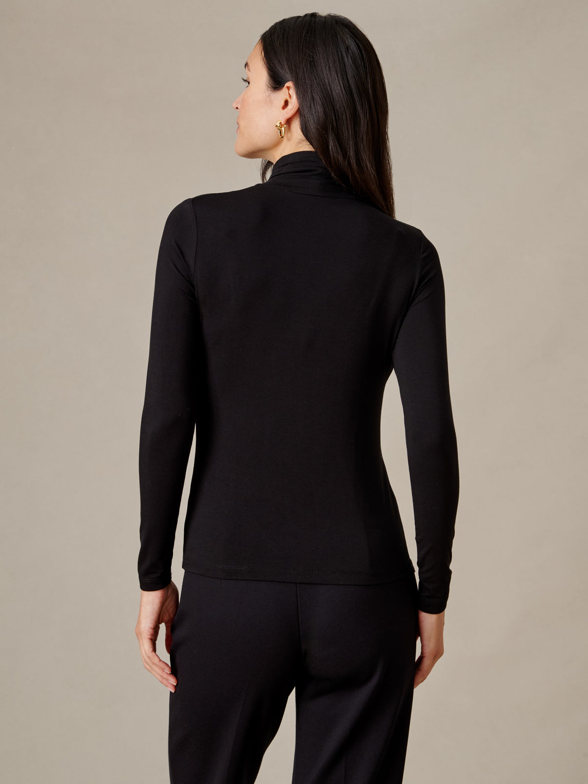 J.McLaughlin Nadia Turtleneck black long sleeve turtleneck top shown from the back on a model with a sleek fitted silhouette