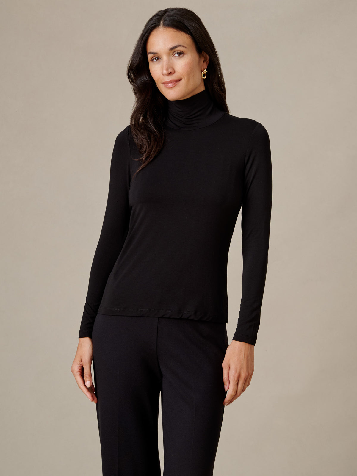 J.McLaughlin Nadia Turtleneck in black with long sleeves and a fitted silhouette styled with black pants for a timeless wardrobe look