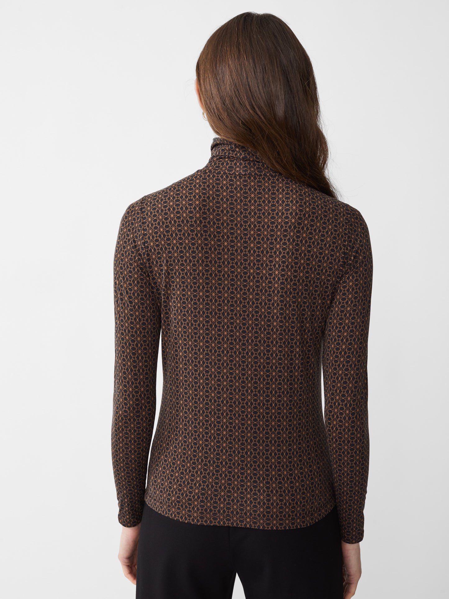 Model wearing J.McLaughlin Nadia turtleneck in black/brown made with Lyford Jersey.