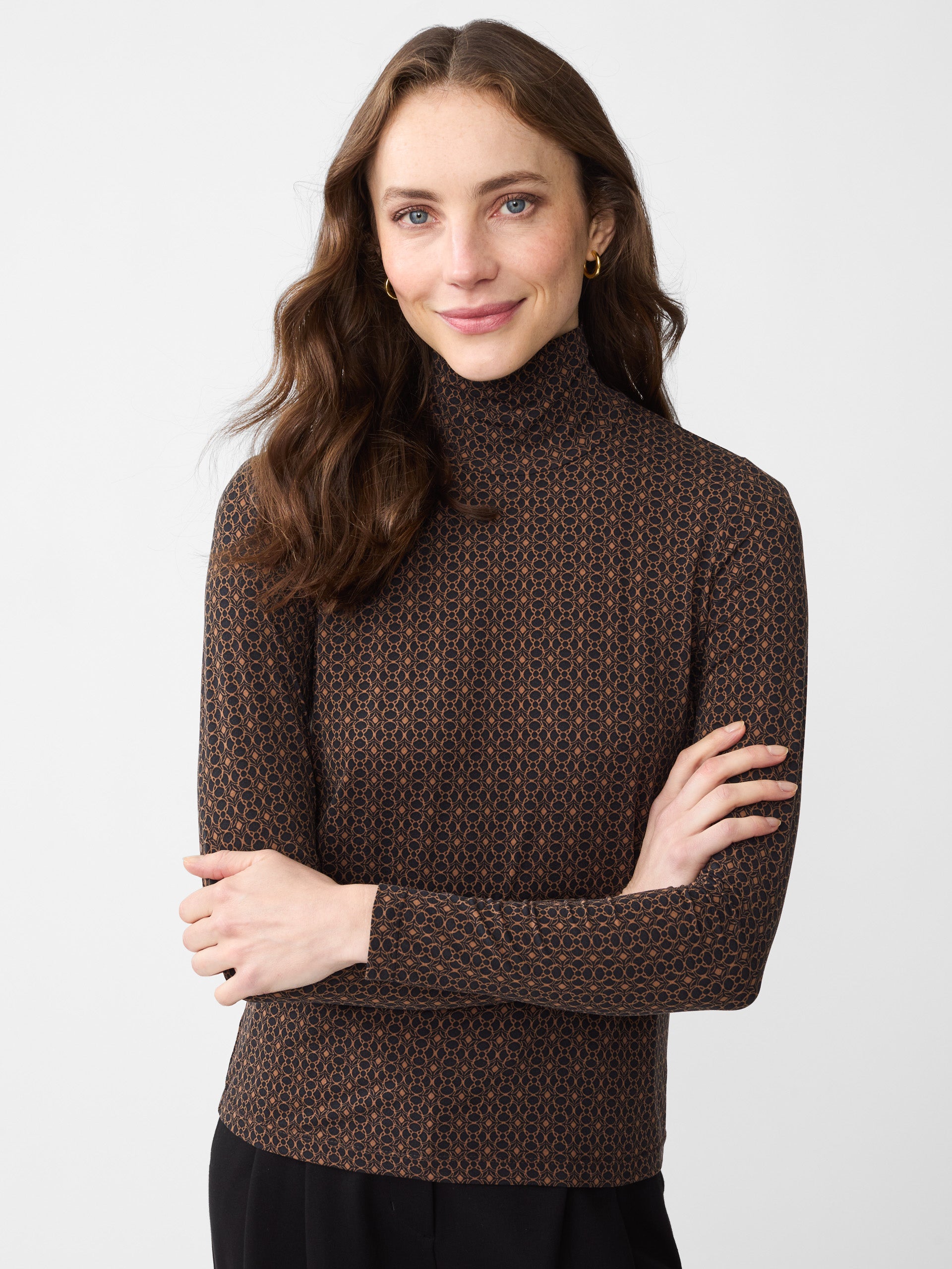 Model wearing J.McLaughlin Nadia turtleneck in black/brown made with Lyford Jersey.