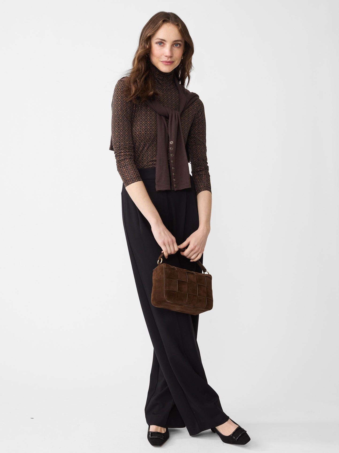 Model wearing J.McLaughlin Nadia turtleneck in black/brown made with Lyford Jersey.