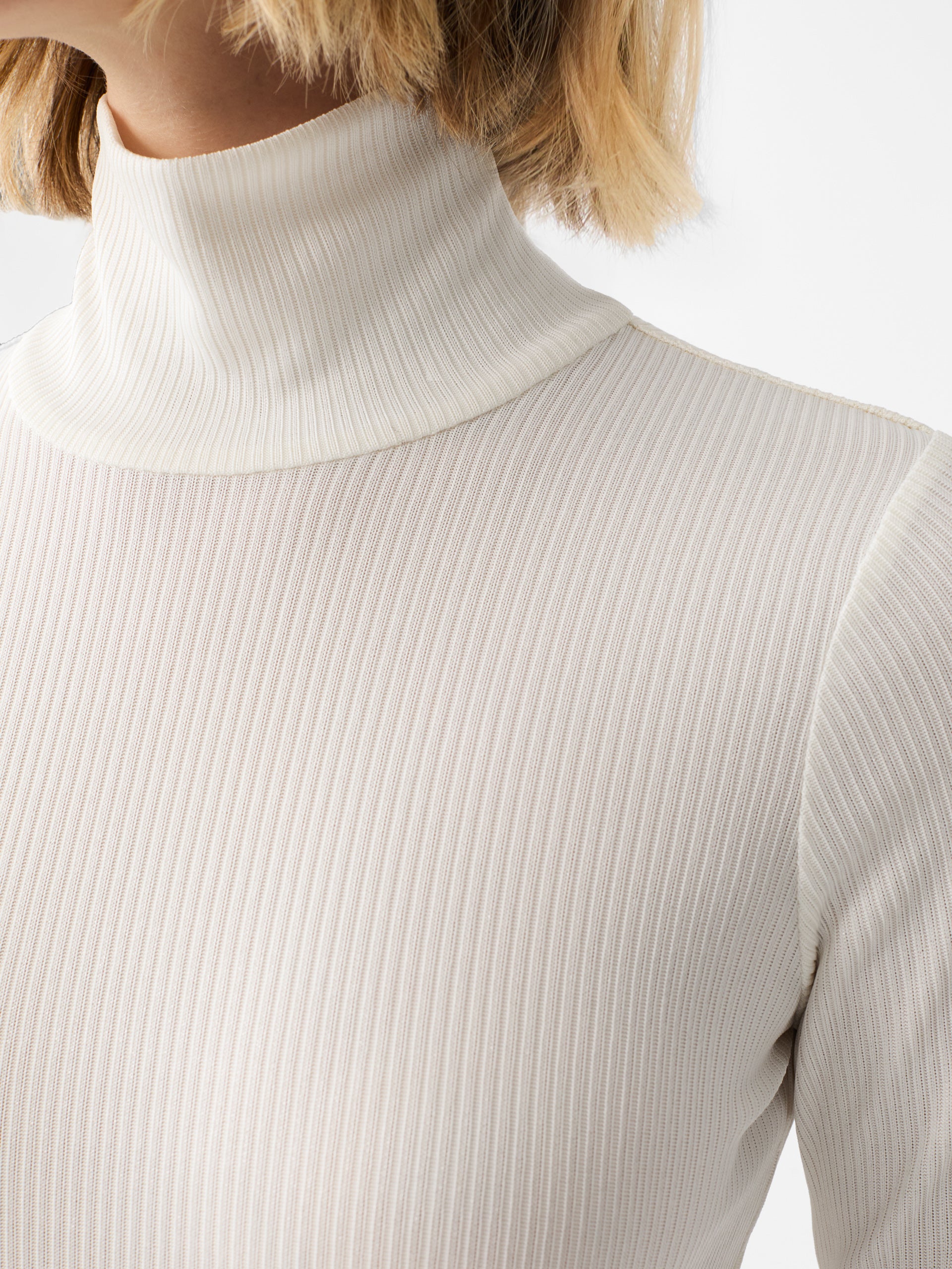 J.McLaughlin Nadia turtleneck in cream/silver made with metallic ribbed knit fabric.