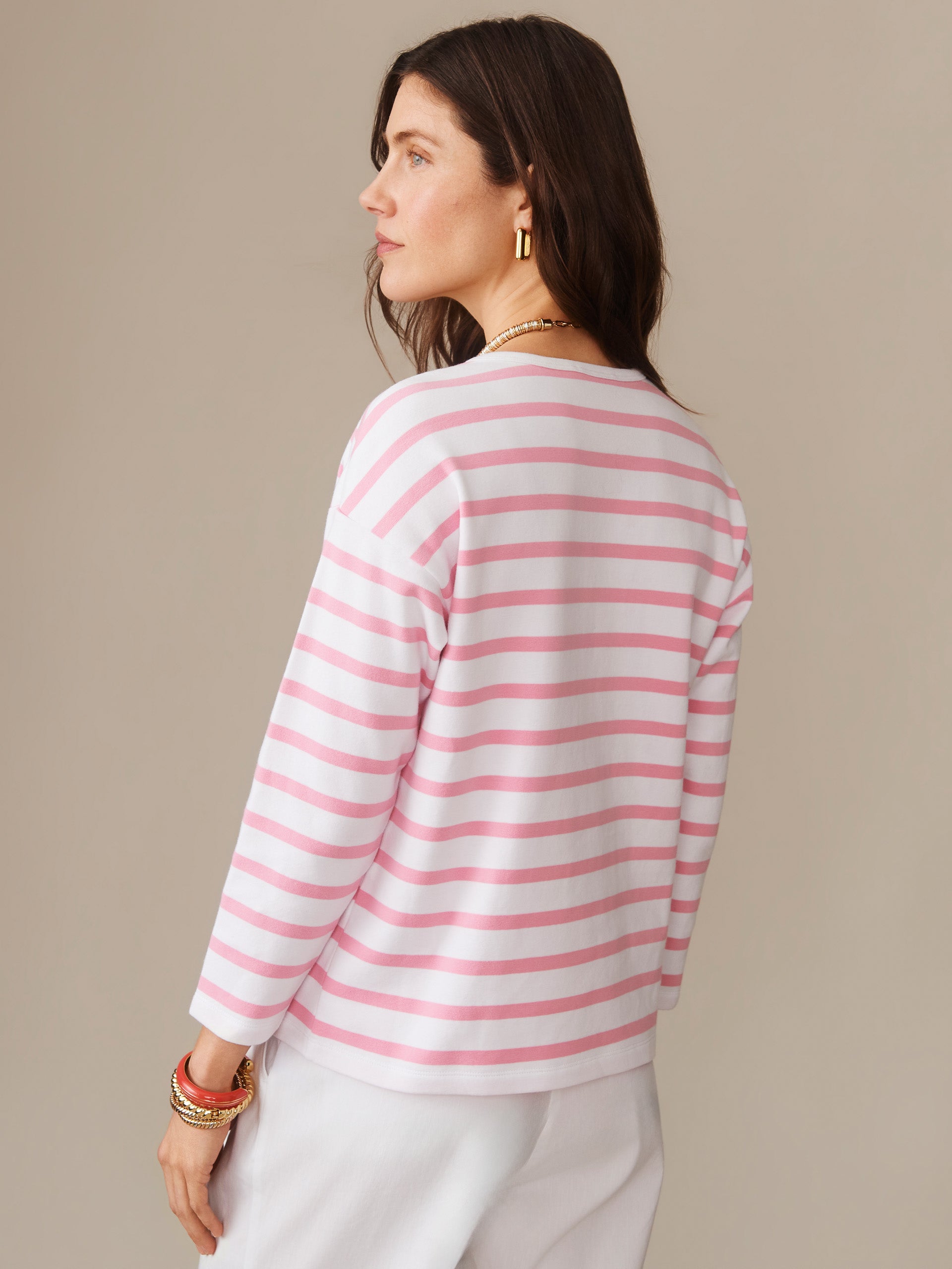 Woman wearing a pink and white striped Nico Tee in Stripe by J.McLaughlin, showcasing effortlessly stylish, enduring designs and innovative fabrics for a legacy of timeless fashion. A destination for defining style. Life, Well-Lived.
