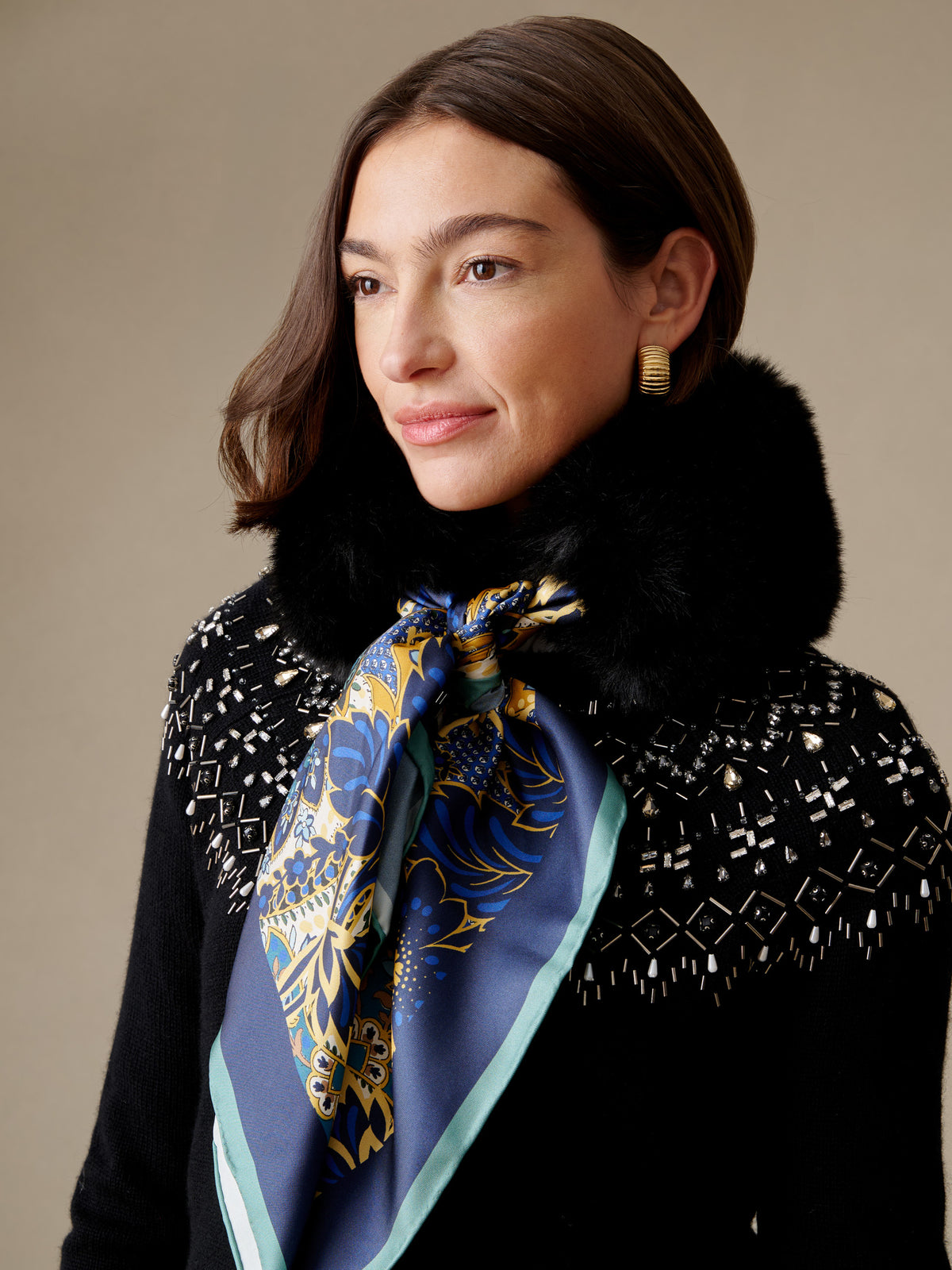 J.McLaughlin Camille Faux Fur Neckwarmer in Imperial Paisley Square with a blue and gold paisley silk scarf and plush black faux fur trim worn around the neck